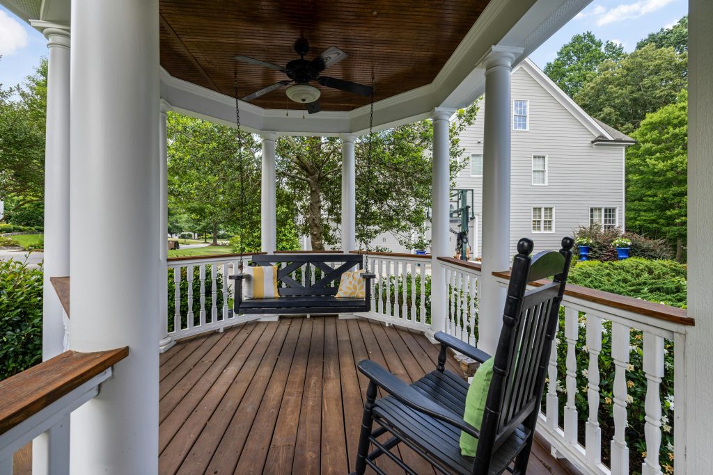 Inviting porch with rocking chair and swing, perfect for relaxation.