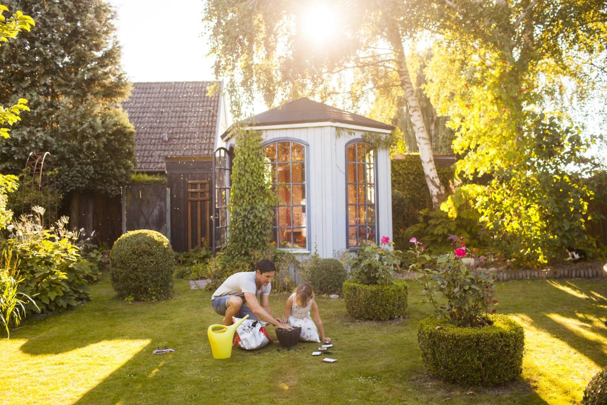 Father with Daughter gardening backyard preparing home for summer home improvement projects